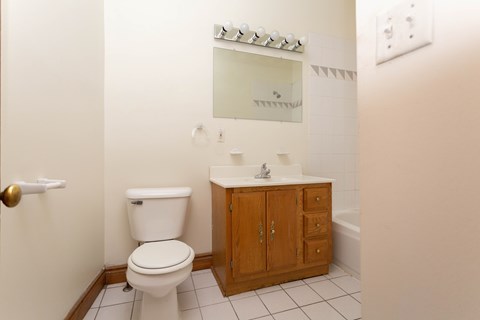 A white toilet sits next to a sink in a bathroom.