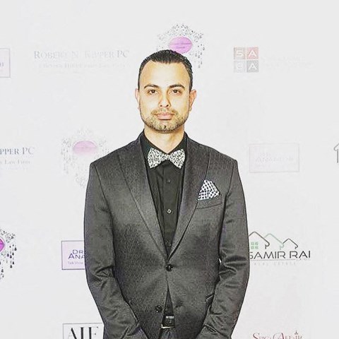 a man in a suit and bow tie
