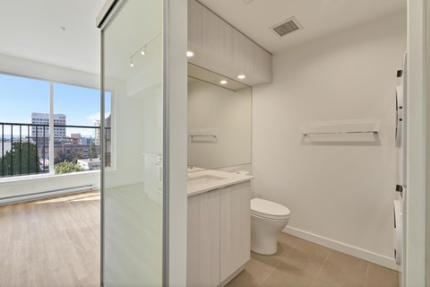 A white bathroom with a toilet and a sink.