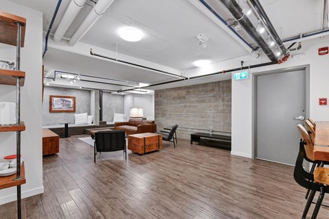 A room with wooden floors and a brick wall.