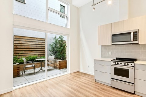 A modern kitchen with a stainless steel oven and microwave.