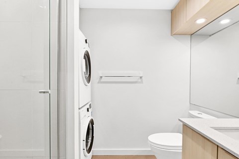 A white washing machine and dryer in a small laundry room.