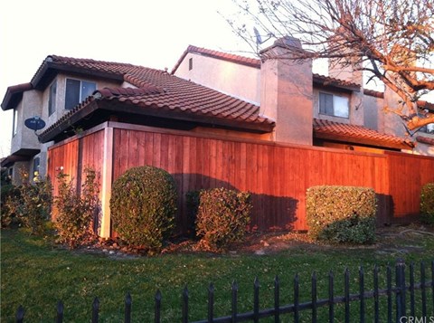 a house with a wooden fence in front of it