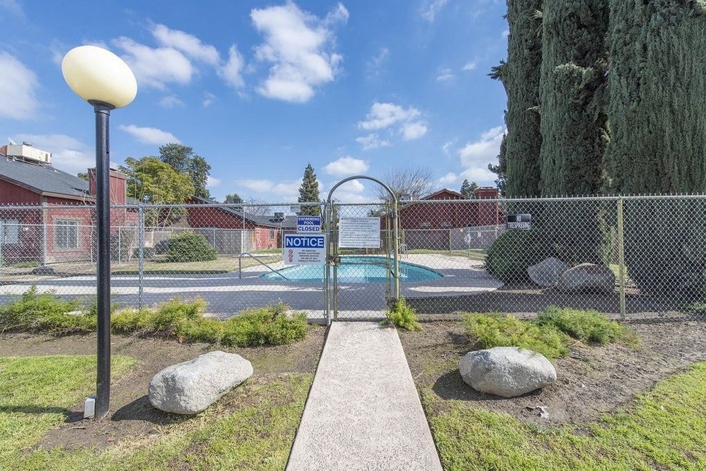 a park with a pool and a fence