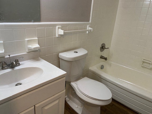 a white bathroom with a toilet and a sink