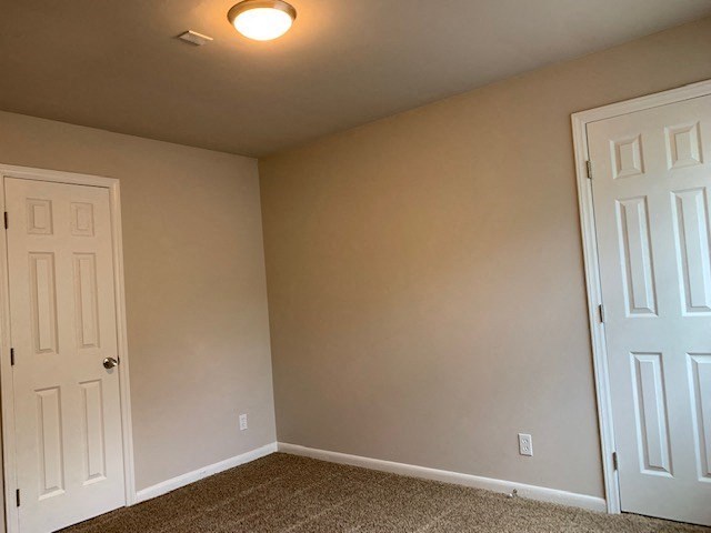 a empty room with a door and a closet
