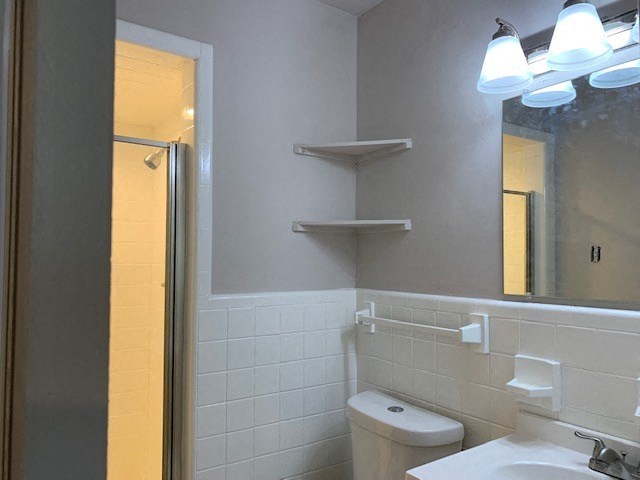 a bathroom with a toilet and a sink and a mirror