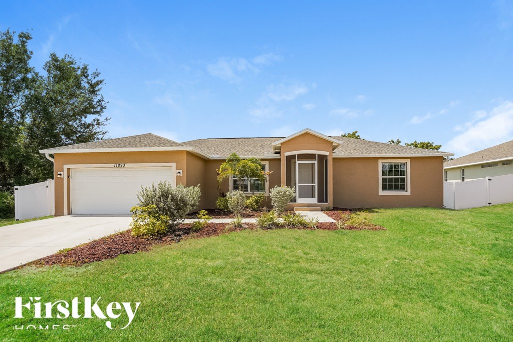 A house with a brown roof and a white garage door is for sale.