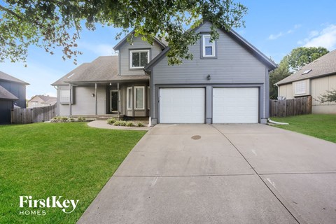 a blue house with a white garage door