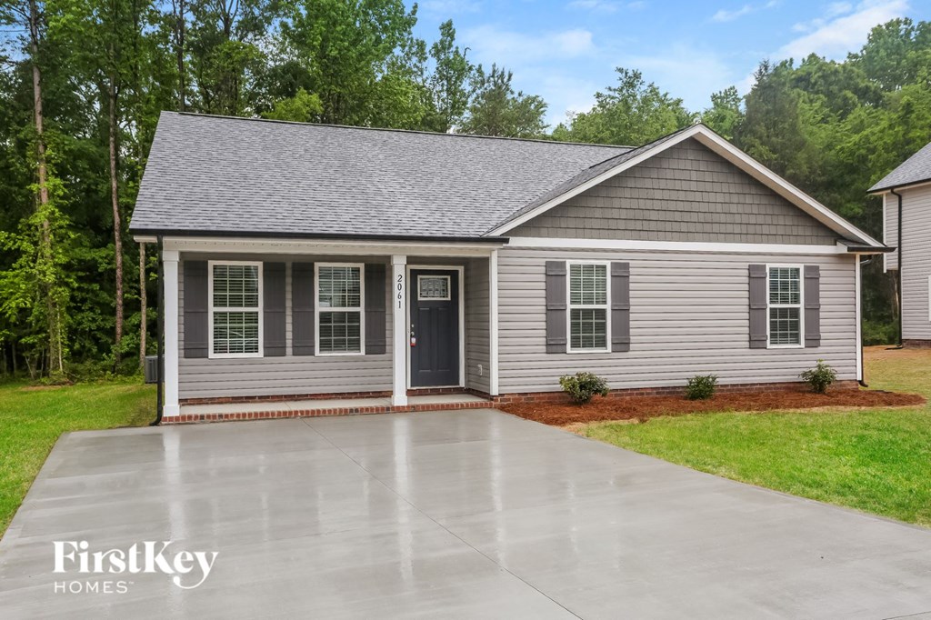 a home with a concrete driveway in front of it