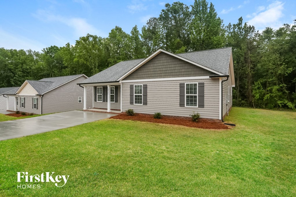 a home with a lawn and a driveway