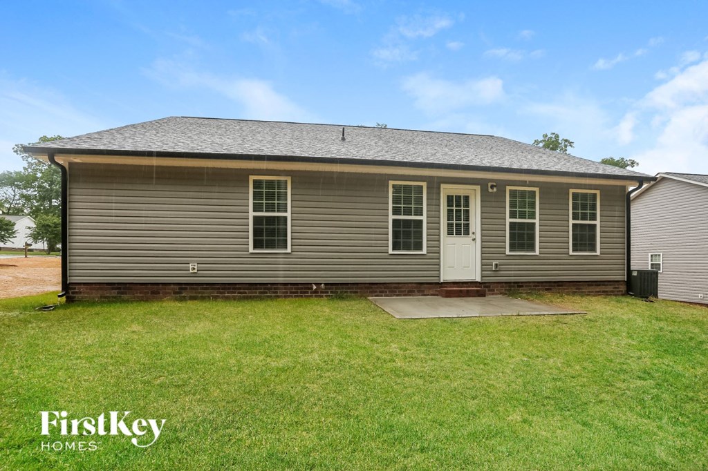 the front of a house with a yard and a white door