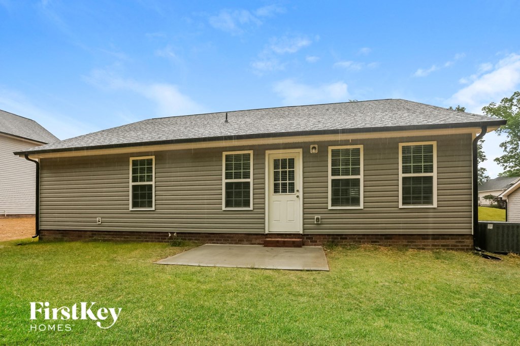 the front of a brown house with a white door