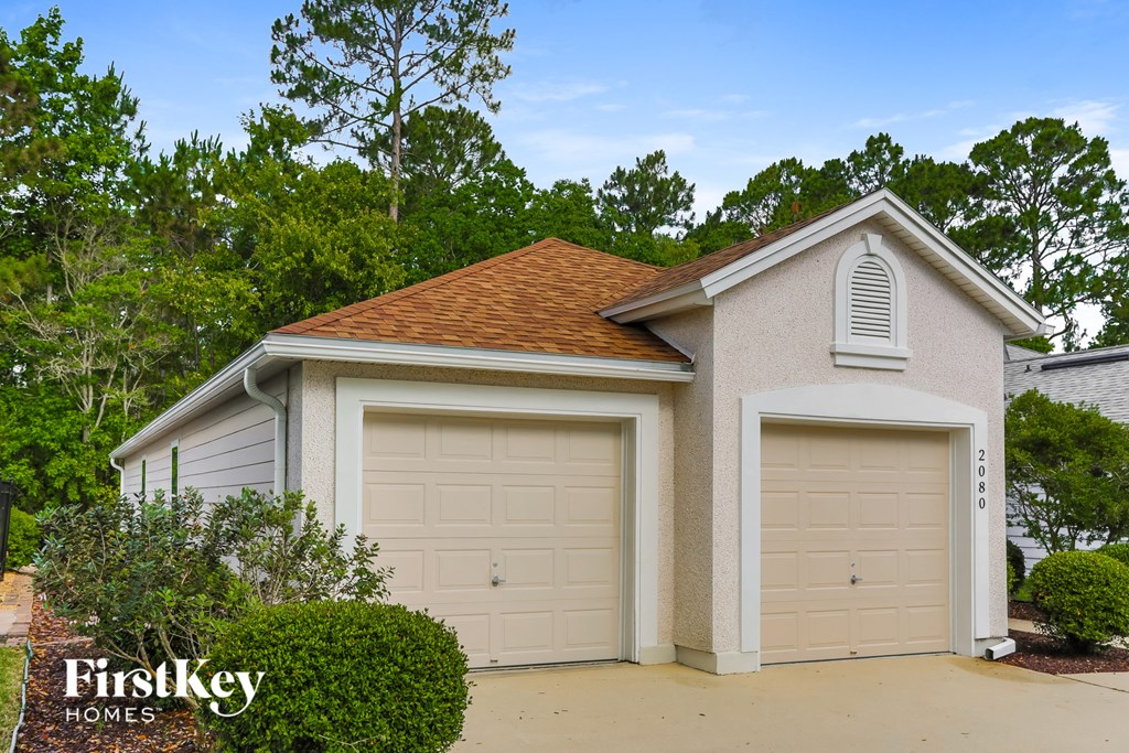 A two-car garage with a FirstKey Homes logo.