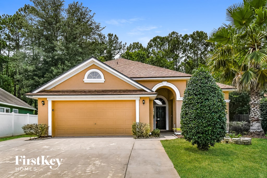 A house with a brown garage door is for sale.