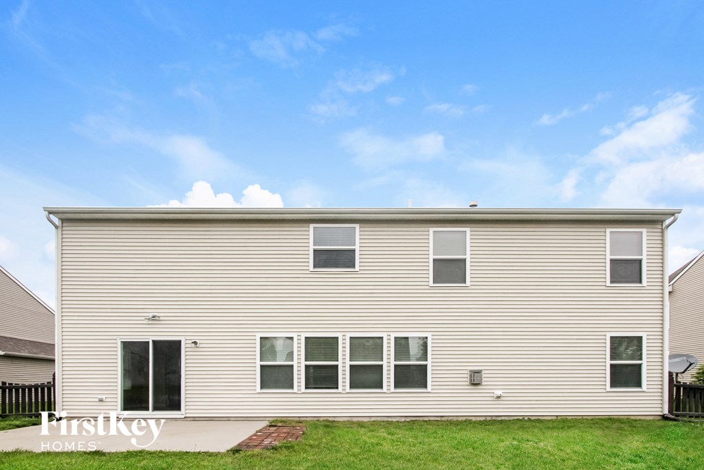 a side view of a house with a blue sky in the background