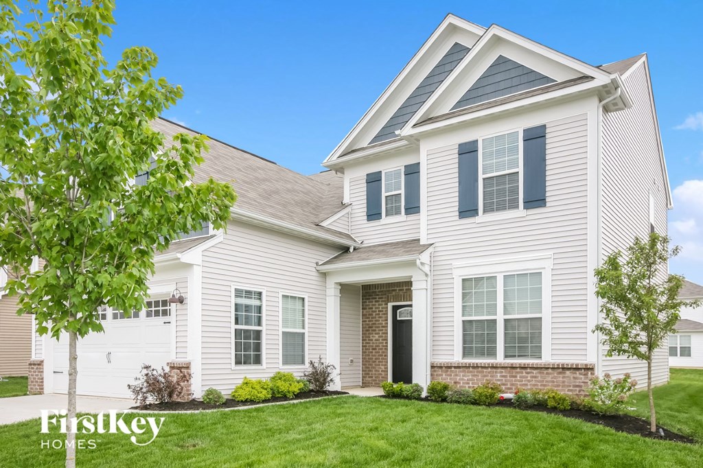 a white house with a lawn in front of it