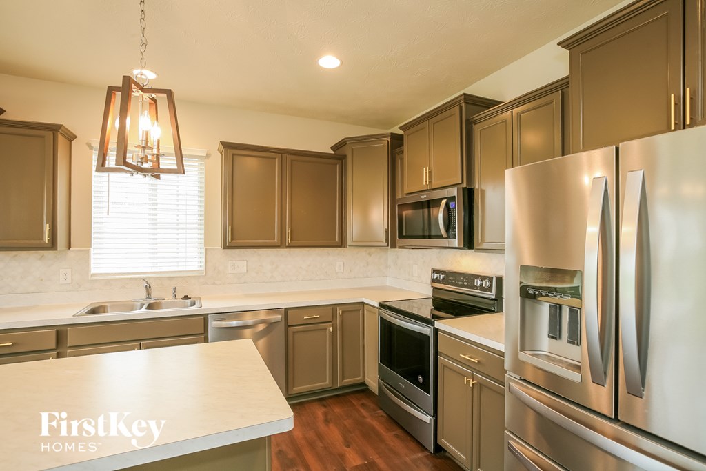 a kitchen with stainless steel appliances and wooden cabinets