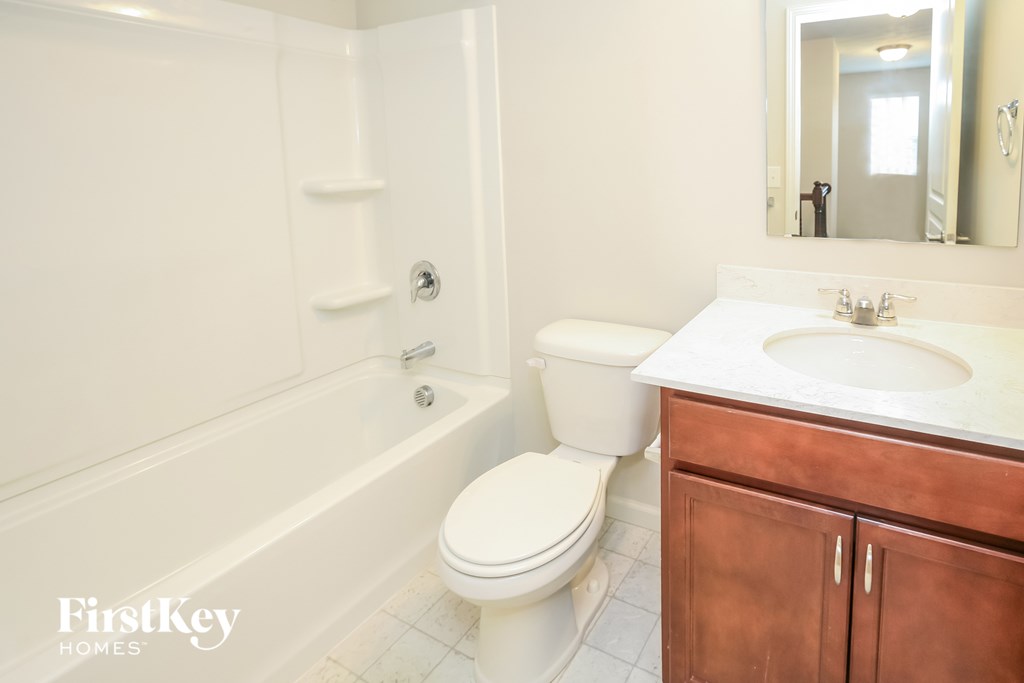 a bathroom with a sink toilet and bath tub