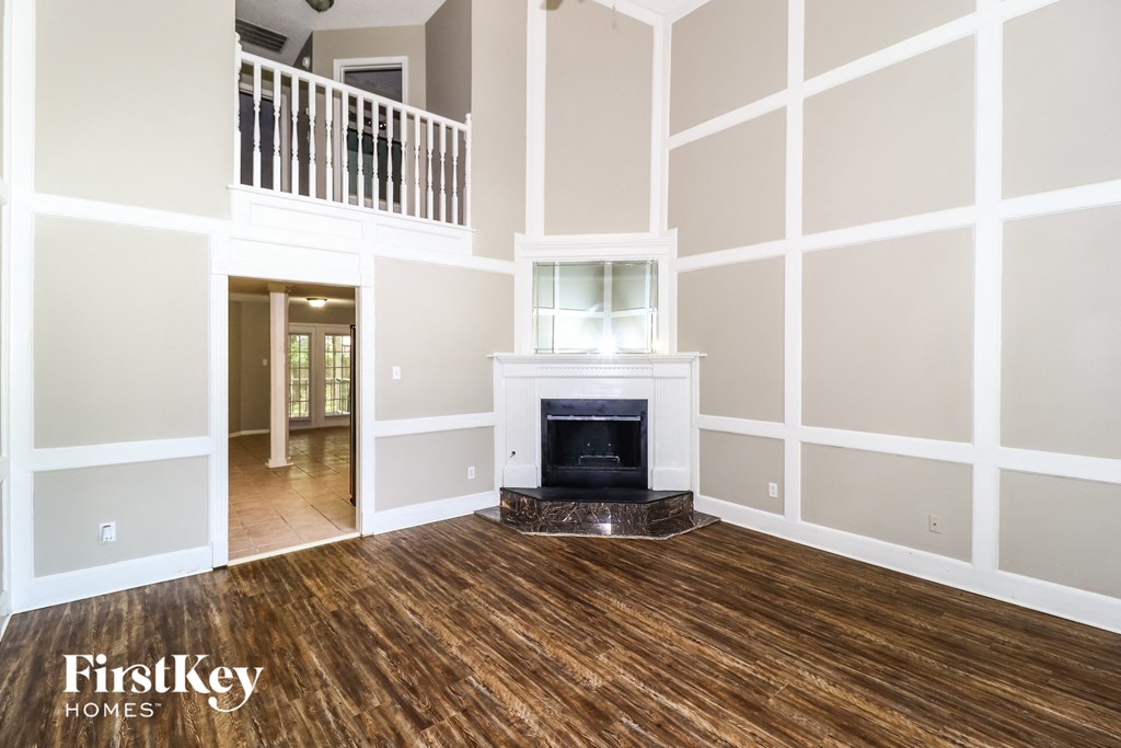 a living room with a fireplace and a wooden floor