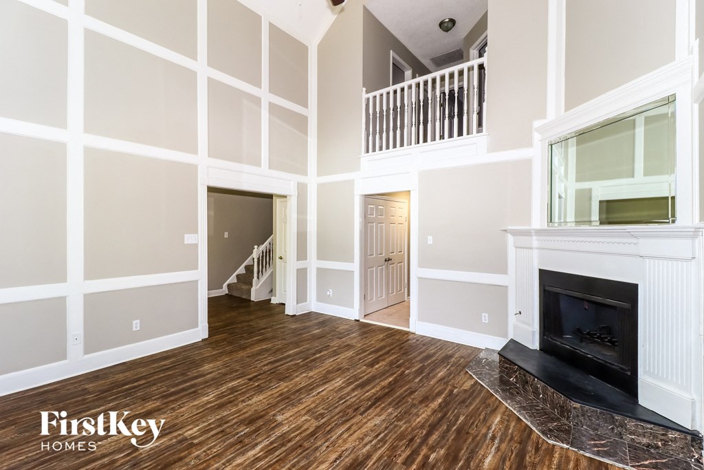 a living room with a fireplace and a staircase