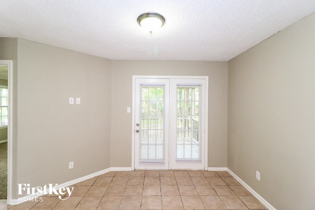 a dining room with a door to a patio