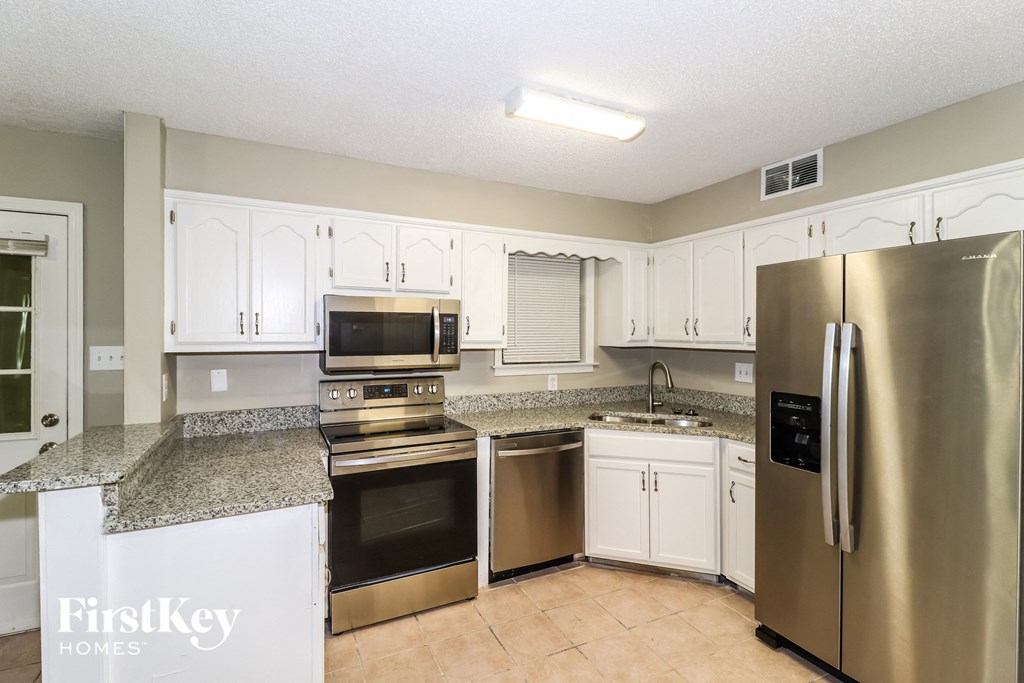 a kitchen with stainless steel appliances and granite counter tops
