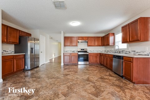 a kitchen with wooden cabinets and stainless steel appliances