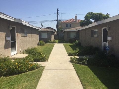 A sunny day in a residential area with houses and a clear sky.