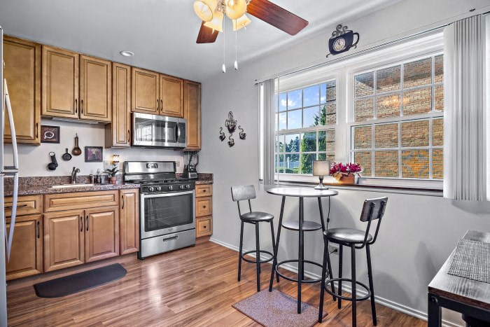 a kitchen with a table and a stove and a window