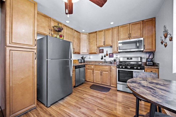 a kitchen with stainless steel appliances and wooden cabinets