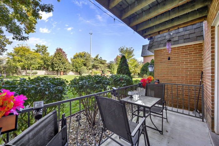 a patio with a table and chairs on a balcony