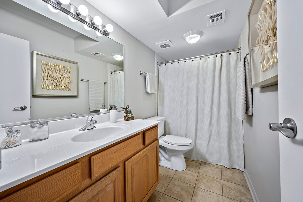 a bathroom with a shower and a sink and a toilet
