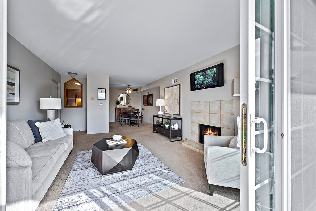 a living room with a white couch and a fireplace