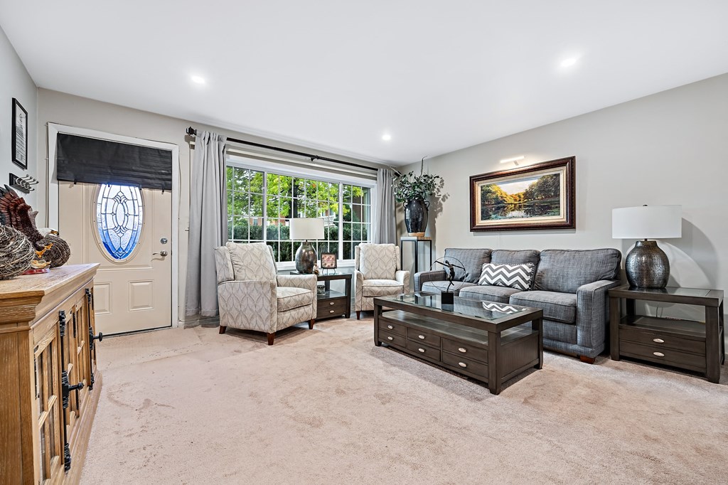 a living room with couches and chairs and a table