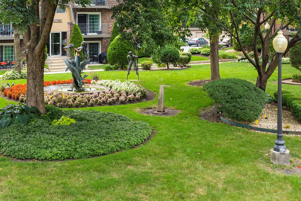 a garden with a statue in the middle of it