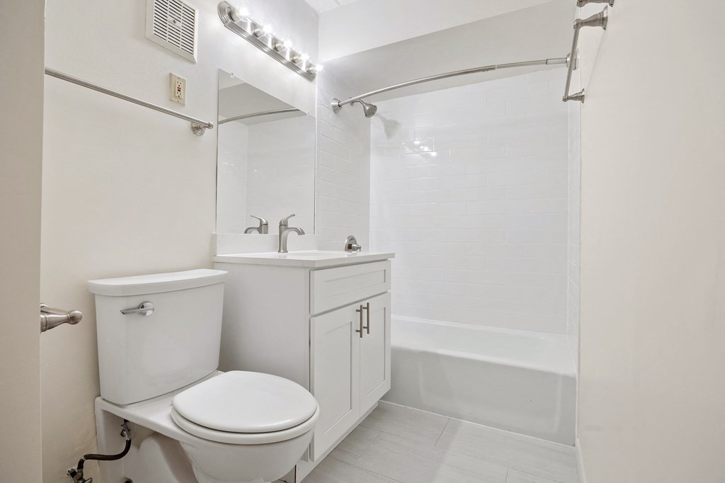 a bathroom with a toilet and a sink and a shower