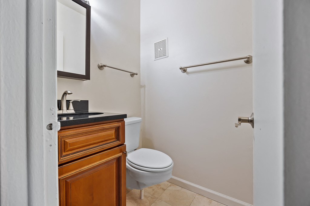 a bathroom with a toilet and a sink and a mirror