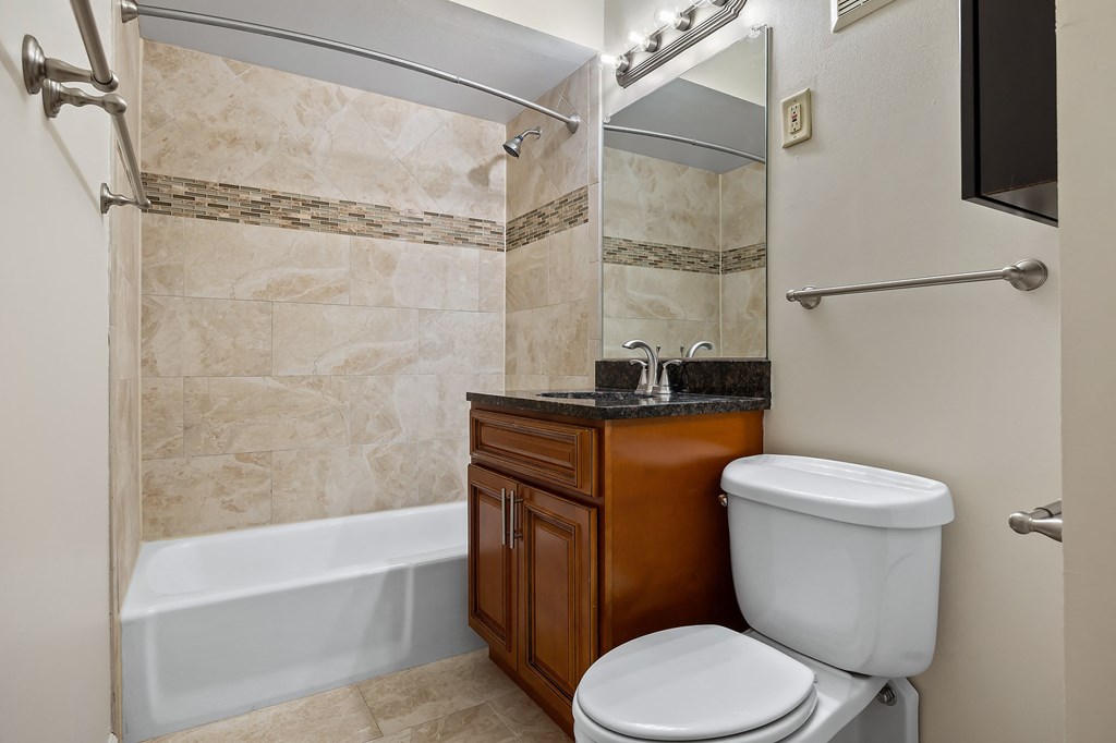 a bathroom with a toilet and a sink and a shower