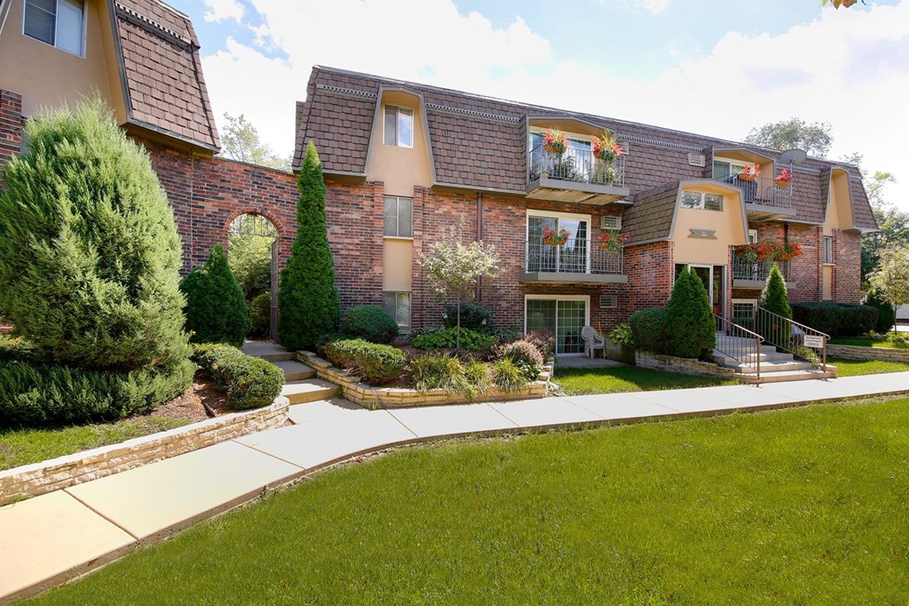 a large house with a sidewalk in front of it