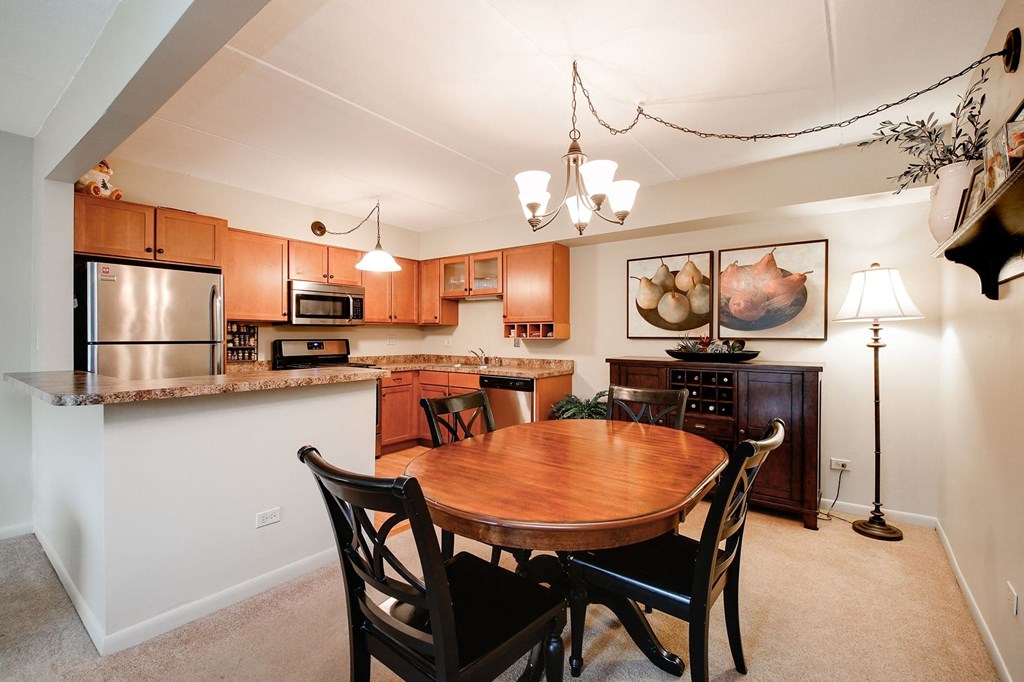 a kitchen and dining room with a wooden table