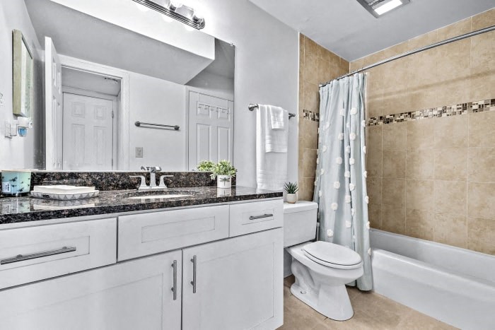 a bathroom with a sink toilet and a shower