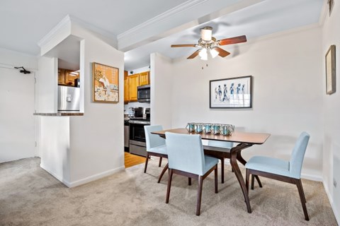 A dining room with a table and chairs.