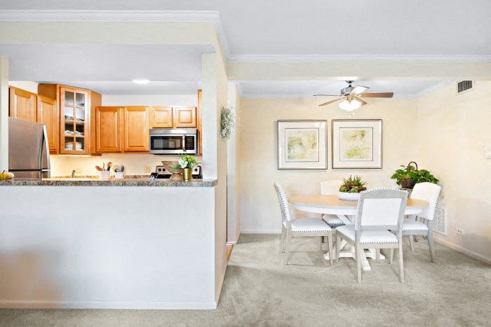 a kitchen and dining room with a white table and chairs