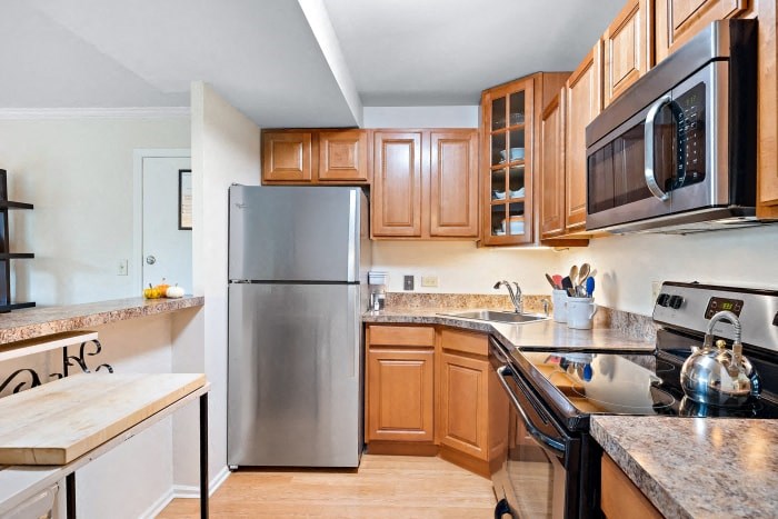 a kitchen with stainless steel appliances and wooden cabinets