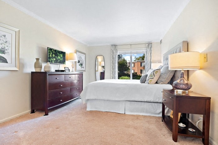 a bedroom with a bed and a dresser