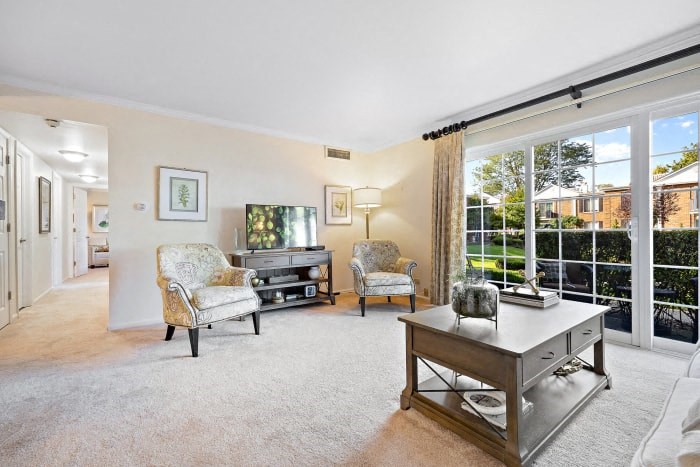 a living room with a large window and a table