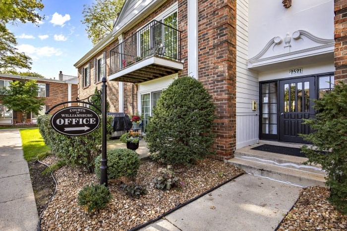 the front of a house with a sign outside of it
