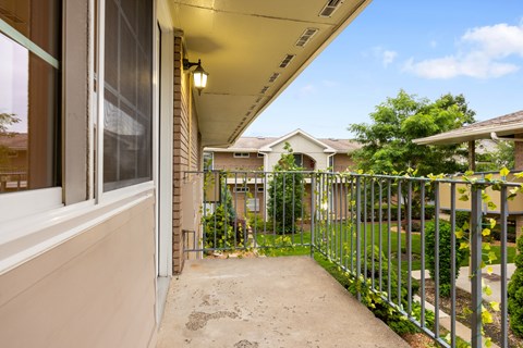 A view of a residential area with houses and a metal fence.