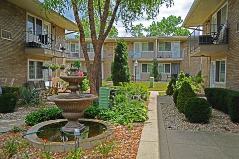 a courtyard with a fountain in front of an apartment building